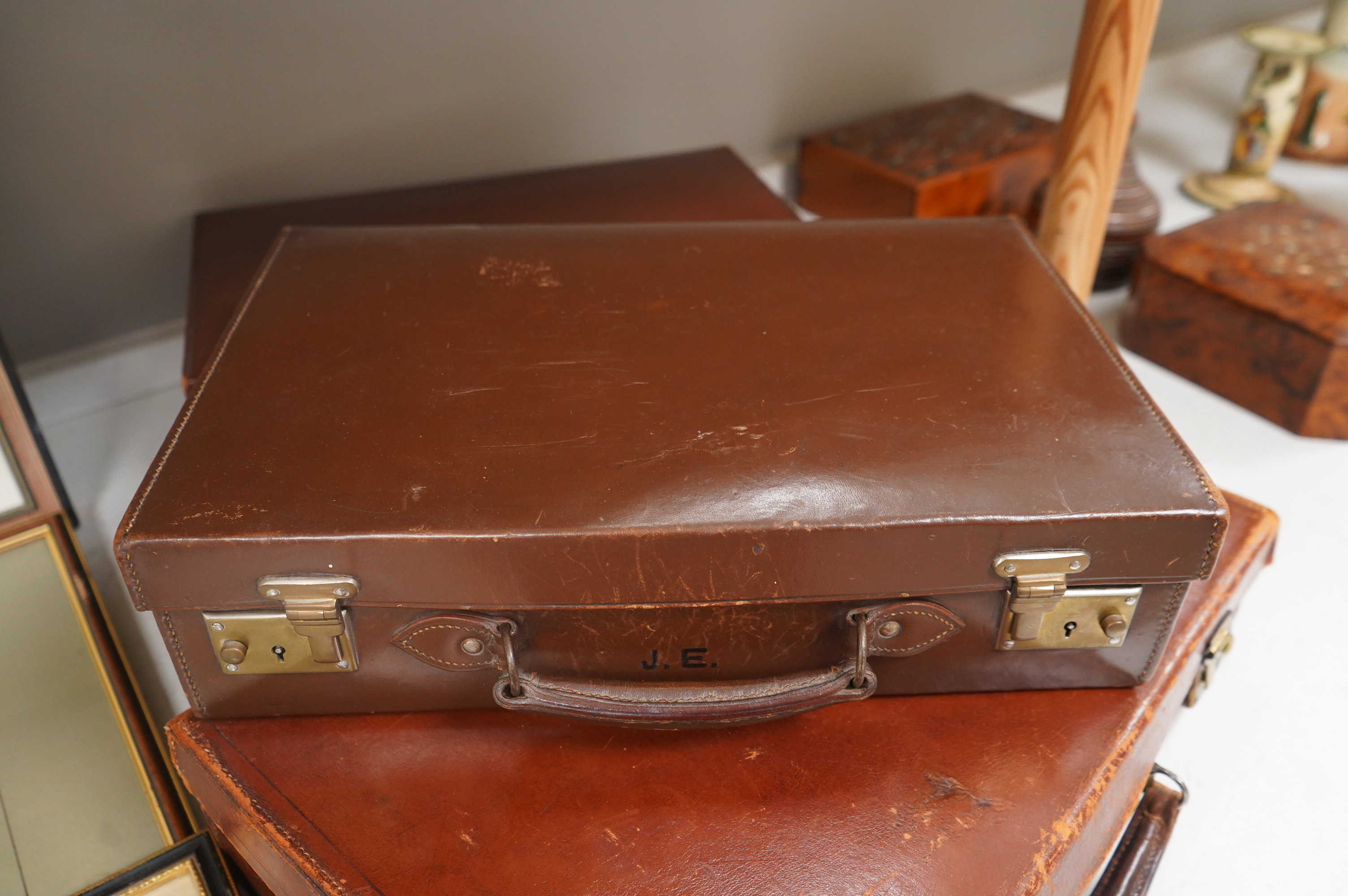 Three small vintage leather cases, largest 45cm wide